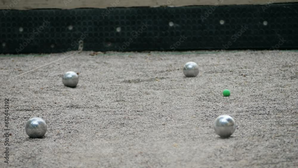 Petanque balls boules bowls on sand gravel court background in Barcelona, spain, traditional french game of petanque on the ground. Petanque balls boules bowls on sand gravel court background in Barcelona, spain, traditional french game of petanque on the ground.