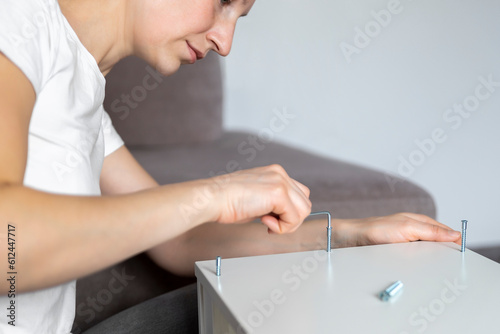Photography Cute adorable caucasian toddler boy kid sit on floor and help mom assembling furniture shelf with screwdriver tool