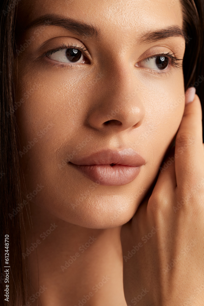 Tender woman with smooth skin looking away