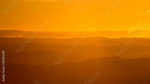 Bright orange sunset over the silhouette of the mountains