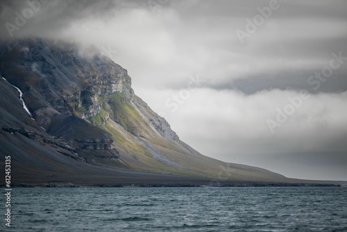Beautiful shot of a landscape with mountains under the clouds in Svalbard, Norway