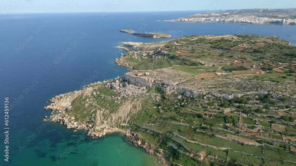 Aerial shot of the rocky mountains on the shore and a crystal clear sea, Malta, Imgiebah Bay Aerial shot of the rocky mountains on the shore and a crystal clear sea, Malta, Imgiebah Bay