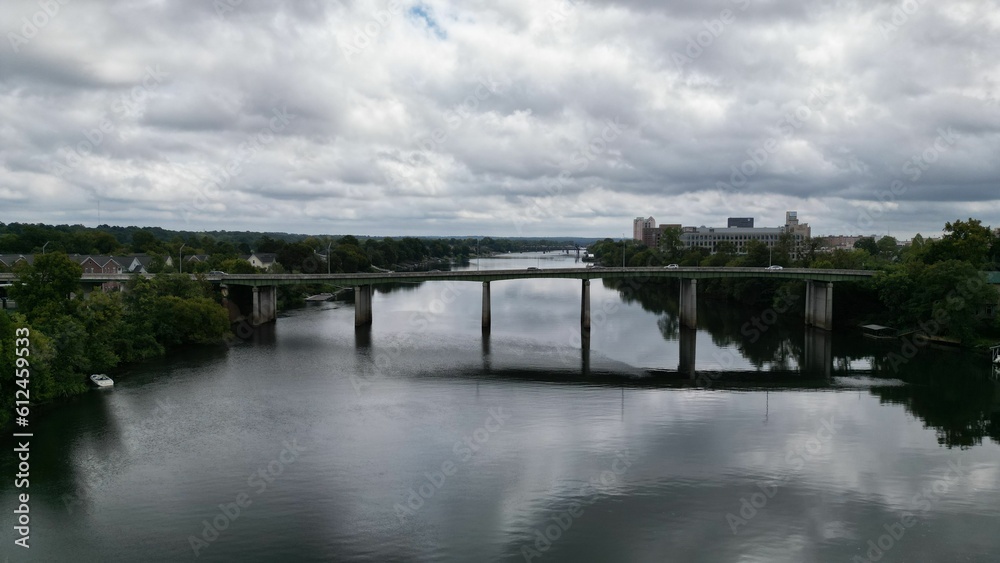 Drone view of a bridge connecting the riverbanks on a cloudy day
