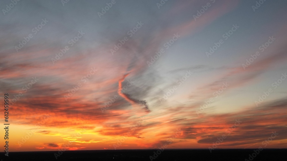 View of the orange-shaded sunset sky with cirrus clouds