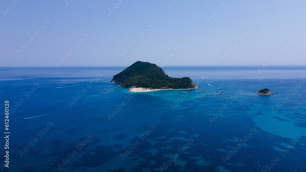 Little island surrounded by a scenic blue seascape