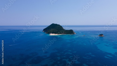Little island surrounded by a scenic blue seascape