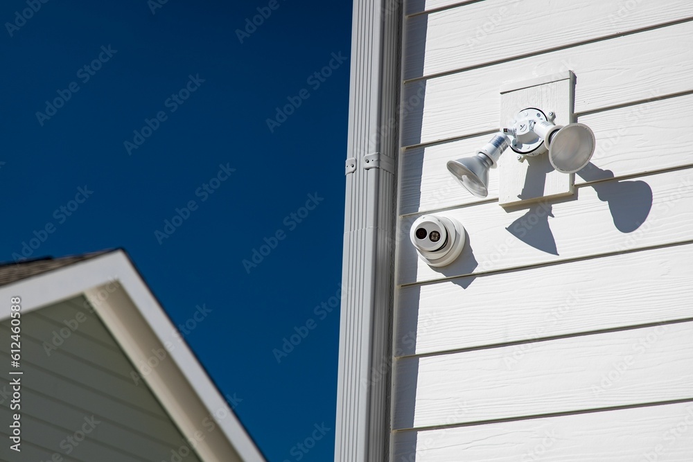 Single-story residential structure with a security camera mounted on the wall Single-story residential structure with a security camera mounted on the wall