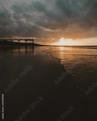 Fototapeta Naklejka Na Ścianę i Meble -  Silhouette shot of the pier at Saltburn beach in Saltburn-by-the-Sea, North Yorkshire
