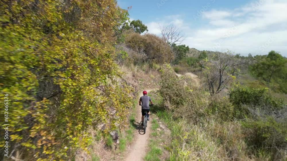 Person riding a bicycle through Pallarenda mountain trail in Townsville, Queensland, Australia