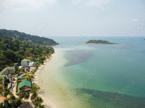 Drone view of Long Beach in Thailand with forests in the background under sunlight