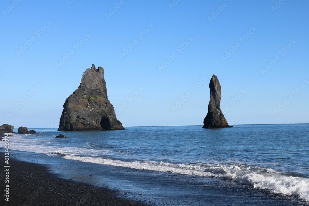Reynisfjara black sand beach with rock formations in Iceland.