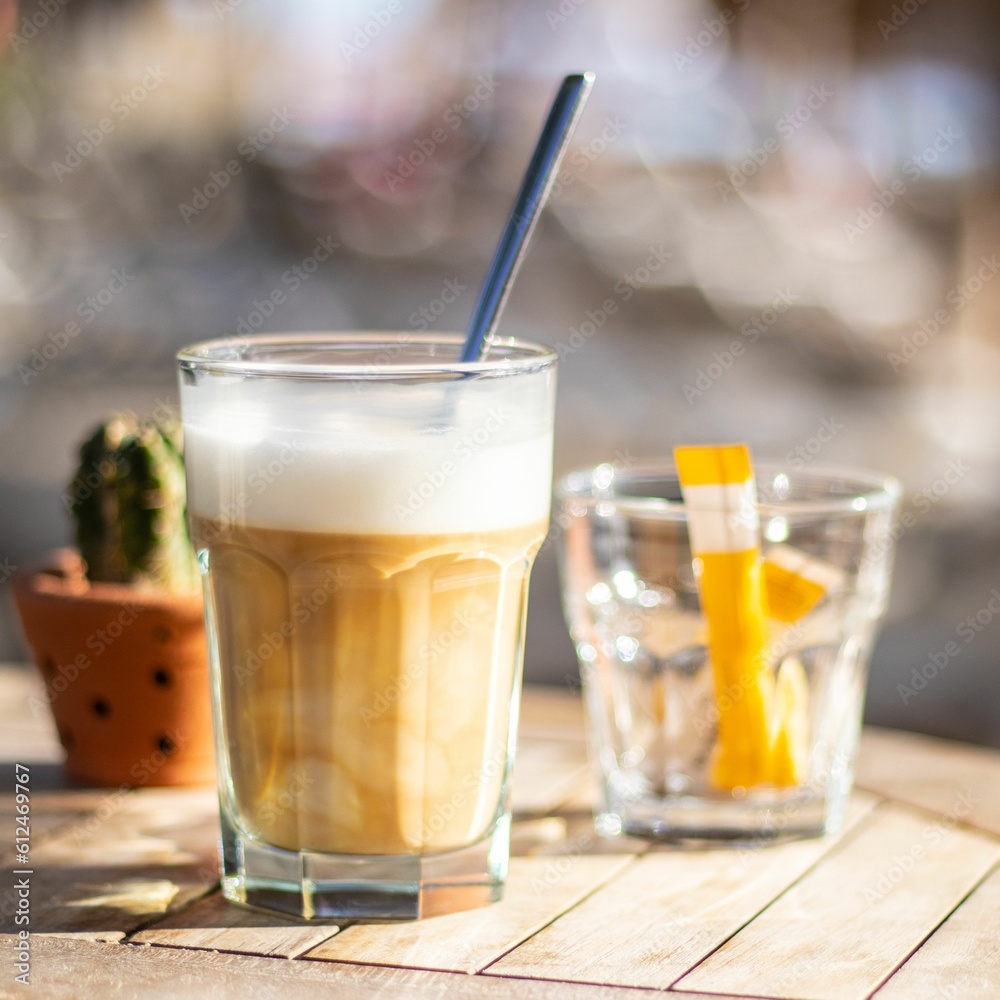 Shallow focus of Latte macchiato refresh drinks on a wooden table with bokeh background Shallow focus of Latte macchiato refresh drinks on a wooden table with bokeh background