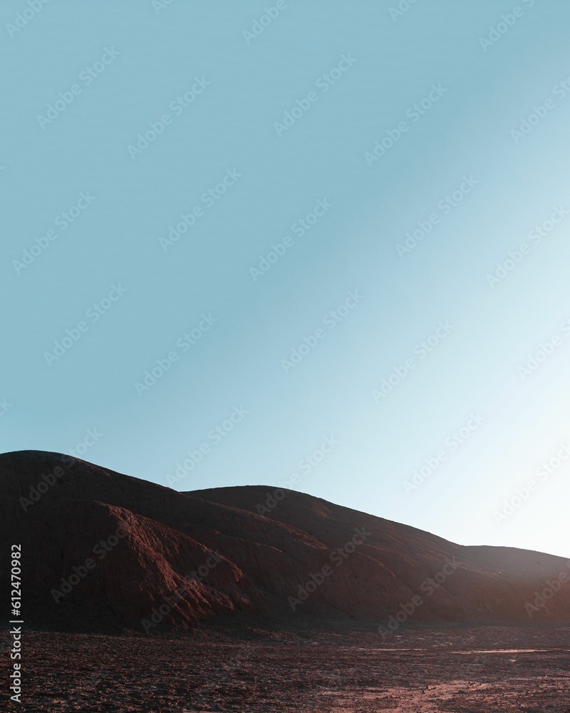 Red dune in Devil's desert under blue sky in Salta, Argentina. Vertical shot