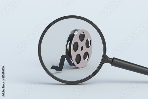 Film reel behind magnifying glass. 3d render