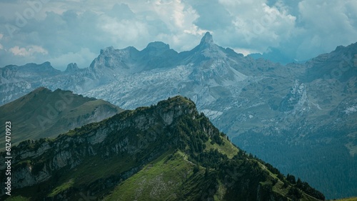 High angle view of mountain peaks surrounded by greenery