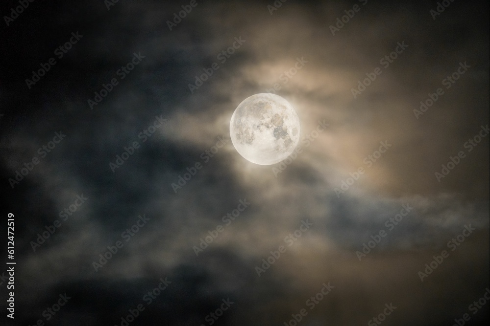 Beautiful full moon in a cloudy dark sky
