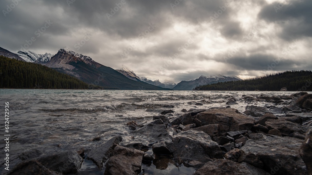 Aerial view of Maligne lake surrounded by dense trees