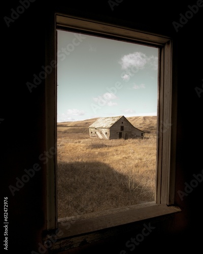 Abandoned barn is seen from a window in the Albertan Badlands, Canada photo