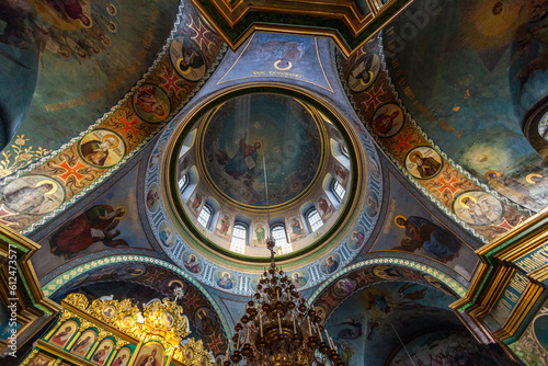 Beautiful dome in an orthodox cathedral  church. Beautiful Christian murals. The sun s rays illuminate the dome beautifully. Beautiful mural with Jesus Christ. Apostles and icons.