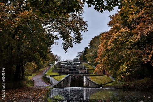Scenic shot of the Five Rise Locks in Bingley and yellow trees captured on an autumn day photo