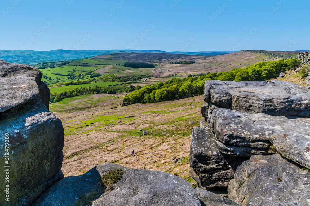 A view through a gap in the millstone at one end of the Stanage Edge escarpment in the Peak District, UK in summertime