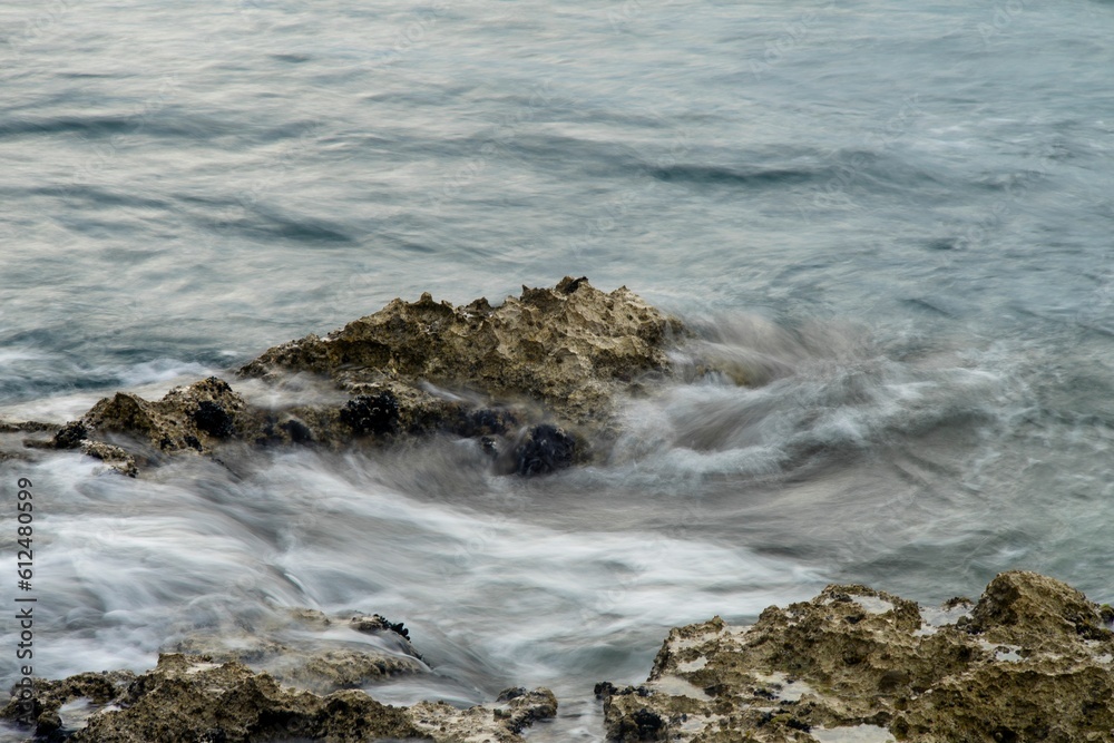 Long exposure of sea waves hitting the rocks