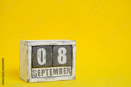 September 08 wooden calendar standing yellow background with an empty space for text.International Literacy Day.