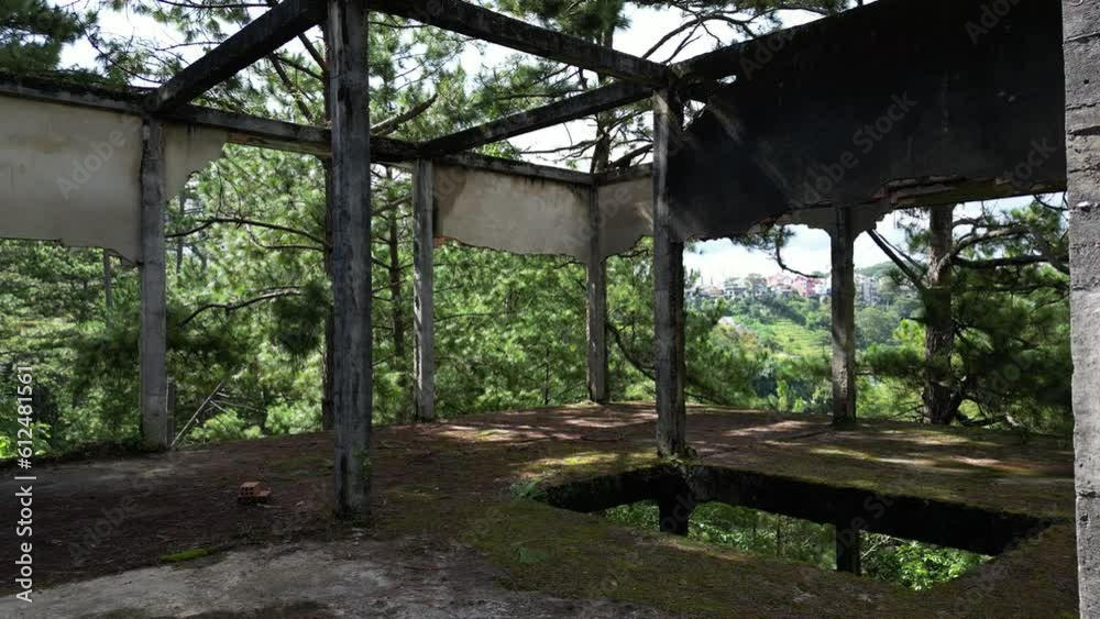 Inside shot of an abandoned veranda with poles and trees outside Inside shot of an abandoned veranda with poles and trees outside