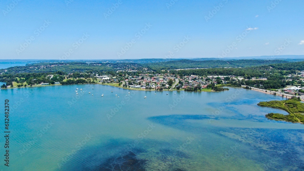 Fototapeta premium Landscape aerial view of Warners Bay lake with blue sky, Australia