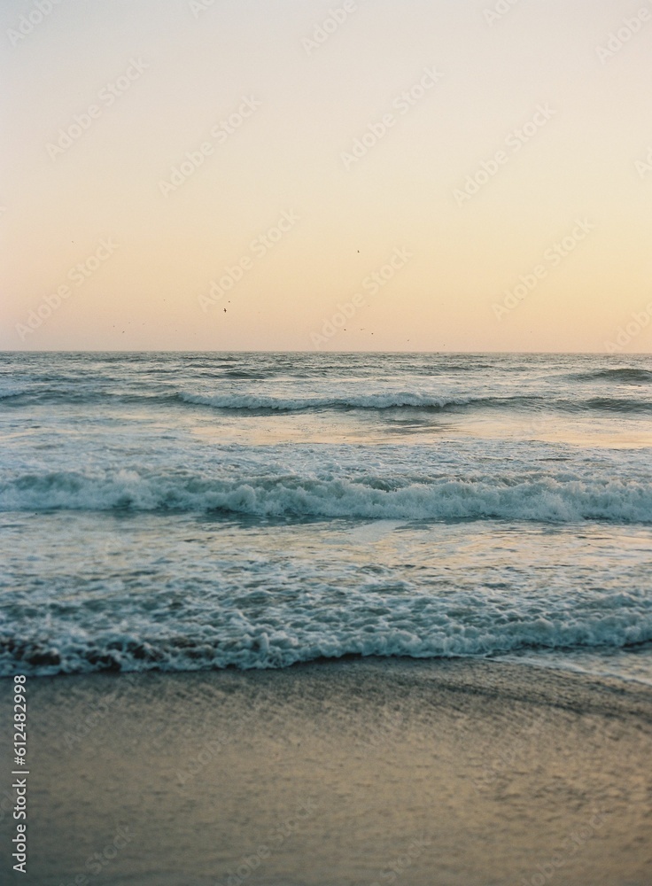 Beautiful shot of waves washing up the sandy beach