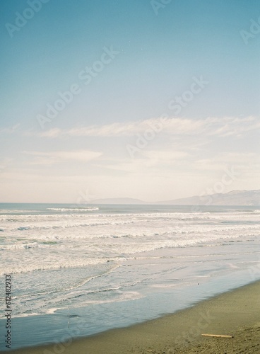 Beautiful shot of waves washing up the sandy beach