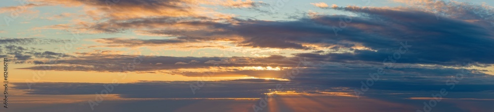 golden clouds after sunset on a dark blue sky