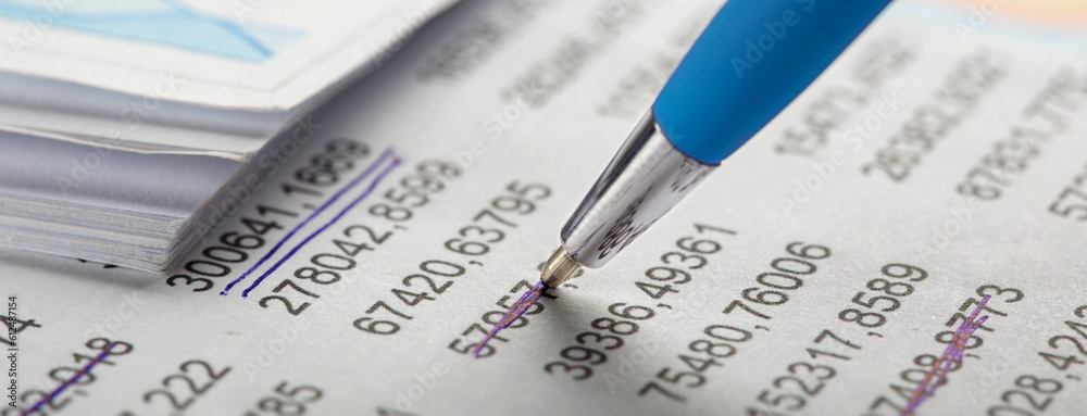 Accounting document with pen, money, coins and checking financial chart. Concept of banking, financial report and financial audit. Accounting document with pen, money, coins and checking financial chart. Concept of banking, financial report and financial audit.