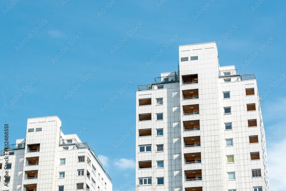 Low angle shot of residential towers in Vienna, Austria against a blue sky