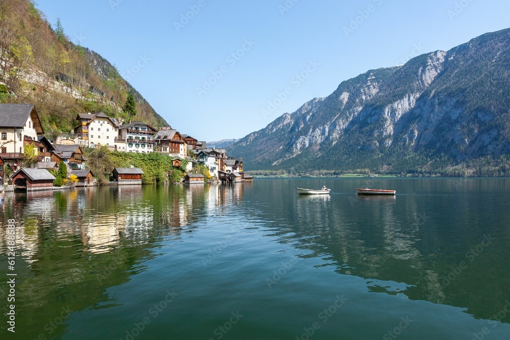 Lakeshore with some floating boats in Hallstatt, Austria