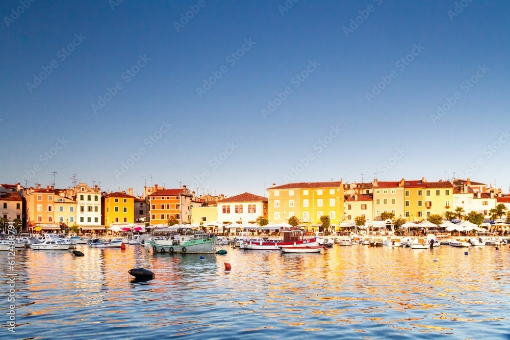 Rovinj old town with historical buildings and sailing boats on the shore, Croatia