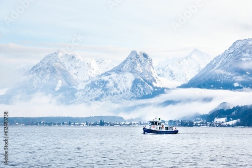 Small ship on lake Wolfgang in Sankt Gilgen, Austria photo