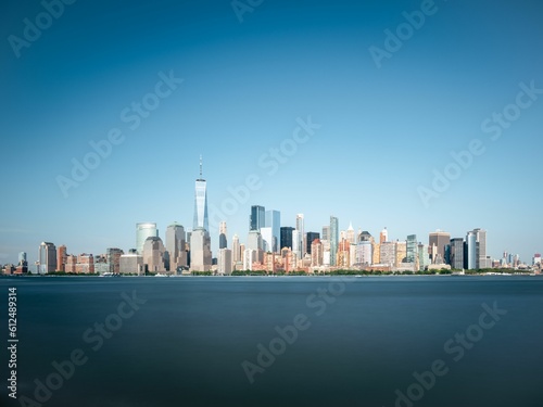 Aerial skyline of Manhattan in New York City, United States on blue sky background © Dimitry Anikin/Wirestock Creators