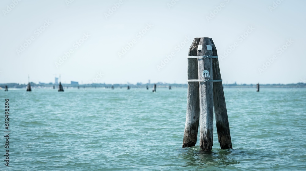 Traditional scene in Venice, Italy. Showing poles of wood surrounded by water Traditional scene in Venice, Italy. Showing poles of wood surrounded by water