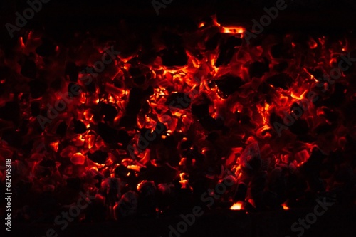 Glowing and flaming hot charcoal briquettes