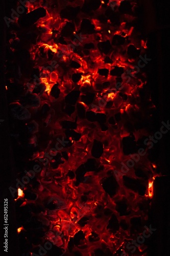 Vertical top view closeup of hot smoldering ashes form a fire