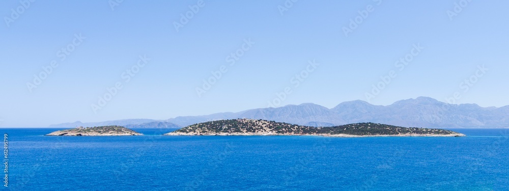 Panoramic shot of an island in the blue sea.