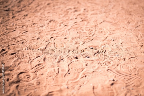 Closeup of the human footprints on the sand in the daytime