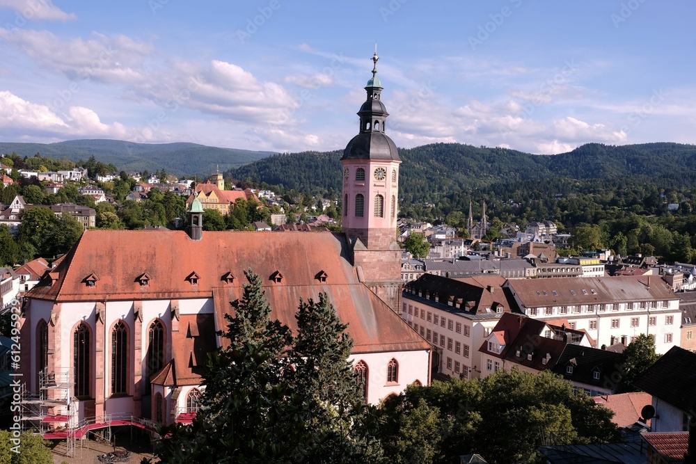 Stiftskirche church in Baden-Baden with hills and forests in the background on a sunny dat