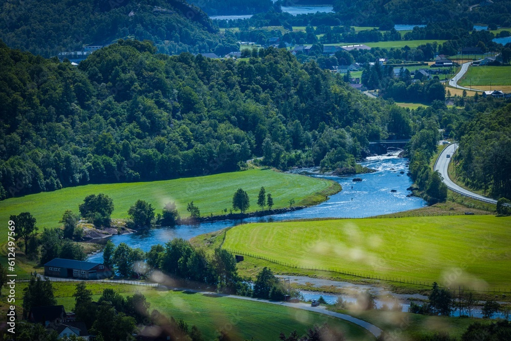 Picturesque landscape of river Stryneelva flowing along a rural settlement on the foot of a mountain Picturesque landscape of river Stryneelva flowing along a rural settlement on the foot of a mountain