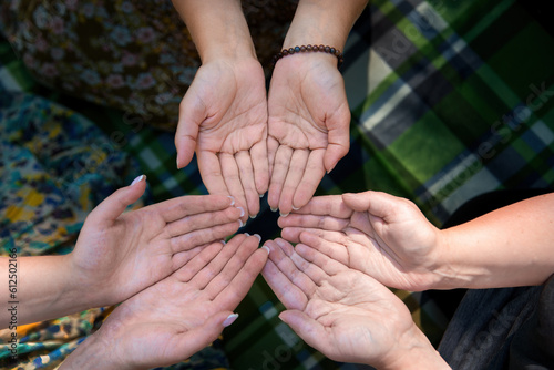 Hands young people close-up  meditating during yoga retreat