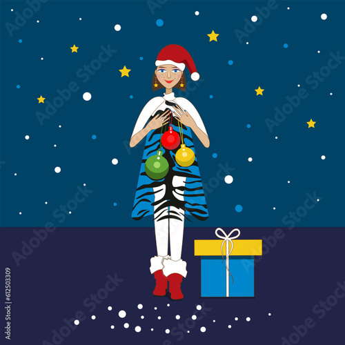 Smiling young girl with Christmas balls and a gift.