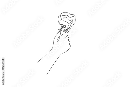 One continuous line drawing of ice cream. Linear hand holding gelato in waffle cone, summer dessert cafe concept. Vector art