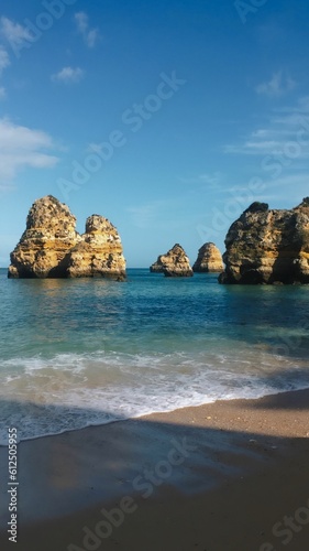 View of the red and yellow rocks in the ocean on the coast of the Algarve in Portugal