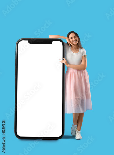 Happy young woman standing ...